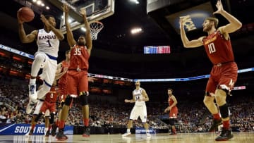 Mar 24, 2016; Louisville, KY, USA; Kansas Jayhawks guard Wayne Selden Jr. (1) passes the ball against Maryland Terrapins forward Damonte Dodd (35) during the first half in a semifinal game in the South regional of the NCAA Tournament at KFC YUM!. Mandatory Credit: Jamie Rhodes-USA TODAY Sports