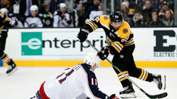 BOSTON, MA - DECEMBER 18: Columbus Blue Jackets left wing Matt Calvert (11) defends against Boston Bruins left wing Brad Marchand (63) during a game between the Boston Bruins and the Columbus Blue Jackets on December 18, 2017, at TD Garden in Boston, Massachusetts. The Bruins defeated the Blue Jackets 7-2. (Photo by Fred Kfoury III/Icon Sportswire via Getty Images)