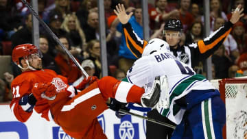 Dec 18, 2015; Detroit, MI, USA; Vancouver Canucks defenseman Matt Bartkowski (44) shoves Detroit Red Wings left wing Tomas Tatar (21) in the third period at Joe Louis Arena. Vancouver won 4-3 in a overtime shootout. Mandatory Credit: Rick Osentoski-USA TODAY Sports