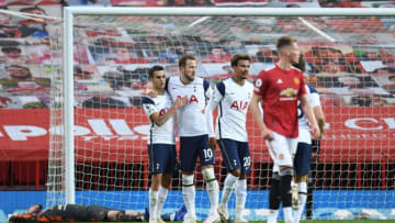 Tottenham Hotspur's English striker Harry Kane (C) celebrates scoring his team's sixth goal from the penalty spot as Manchester United's Spanish goalkeeper David de Gea (L) lies on the floor during the English Premier League football match between Manchester United and Tottenham Hotspur at Old Trafford in Manchester, north west England, on October 4, 2020. (Photo by Oli SCARFF / AFP) / RESTRICTED TO EDITORIAL USE. No use with unauthorized audio, video, data, fixture lists, club/league logos or 'live' services. Online in-match use limited to 120 images. An additional 40 images may be used in extra time. No video emulation. Social media in-match use limited to 120 images. An additional 40 images may be used in extra time. No use in betting publications, games or single club/league/player publications. / (Photo by OLI SCARFF/AFP via Getty Images)