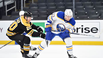 May 1, 2021; Boston, Massachusetts, USA; Buffalo Sabres left wing Jeff Skinner (53) tries to gain control of the puck while Boston Bruins center Curtis Lazar (20) pursues during the third period at TD Garden. Mandatory Credit: Bob DeChiara-USA TODAY Sports