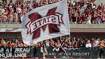 STARKVILLE, MISSISSIPPI - OCTOBER 08: A Mississippi State Bulldogs cheerleaders runs with the flag before the game against the Arkansas Razorbacks at Davis Wade Stadium on October 08, 2022 in Starkville, Mississippi. (Photo by Justin Ford/Getty Images)