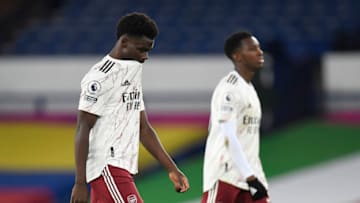 LIVERPOOL, ENGLAND - DECEMBER 19: Bukayo Saka of Arsenal and Eddie Nketiah of Arsenal look dejected at half time during the Premier League match between Everton and Arsenal at Goodison Park on December 19, 2020 in Liverpool, England. A limited number of fans (2000) are welcomed back to stadiums to watch elite football across England. This was following easing of restrictions on spectators in tiers one and two areas only. (Photo by Peter Powell -