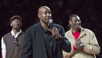 Feb 7, 2015; Fayetteville, AR, USA; Fromer NBA and Arkansas Razorbacks player Sidney Moncrief talks to the crowd during a banner unveiling as Ron Brewer (left) and Marvin Delph look on during half time of a game at Bud Walton Arena. Moncrief Brewer and Delph were nicknamed The Triplets during their time at Arkansas. Mandatory Credit: Beth Hall-USA TODAY Sports