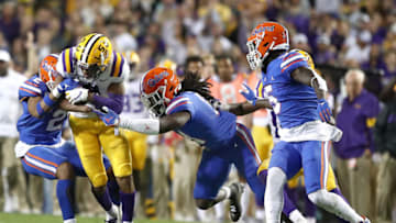 BATON ROUGE, LOUISIANA - OCTOBER 12: Ja'Marr Chase #1 of the LSU Tigers is tackled by Brad Stewart Jr. #2 of the Florida Gators during the fourth quarter at Tiger Stadium on October 12, 2019 in Baton Rouge, Louisiana. (Photo by Marianna Massey/Getty Images)