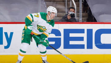 GLENDALE, ARIZONA - MARCH 06: Brad Hunt #77 of the Minnesota Wild skates with the puck against the Arizona Coyotes during the NHL game at Gila River Arena on March 06, 2021 in Glendale, Arizona. The Coyotes defeated the Wild 5-2. (Photo by Christian Petersen/Getty Images)