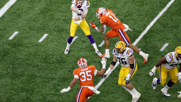 NEW ORLEANS, LOUISIANA - JANUARY 13: Joe Burrow #9 of the LSU Tigers throws a pass against Isaiah Simmons #11 of the Clemson Tigers during the first half in the College Football Playoff National Championship game at Mercedes Benz Superdome on January 13, 2020 in New Orleans, Louisiana. (Photo by Sean Gardner/Getty Images)