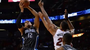 Apr 13, 2015; Miami, FL, USA; Orlando Magic forward Tobias Harris (12) reacts for a rebound with Miami Heat center Hassan Whiteside (21) during the second half at American Airlines Arena. Mandatory Credit: Steve Mitchell-USA TODAY Sports