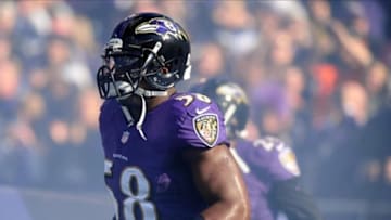 Nov 10, 2013; Baltimore, MD, USA; Baltimore Ravens linebacker Elvis Dumervil (58) runs onto the field prior to the game against the Cincinnati Bengals at M
