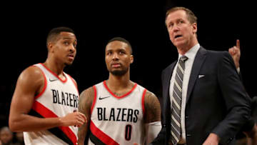 NEW YORK, NY - NOVEMBER 24: CJ McCollum #3 (L), Damian Lillard #0 and Terry Stotts of the Portland Trail Blazers talk late in the fourth quarter against the Brooklyn Nets at Barclays Center on November 24, 2017 in the Brooklyn borough of New York City. NOTE TO USER: User expressly acknowledges and agrees that, by downloading and or using this photograph, User is consenting to the terms and conditions of the Getty Images License Agreement. (Photo by Abbie Parr/Getty Images)