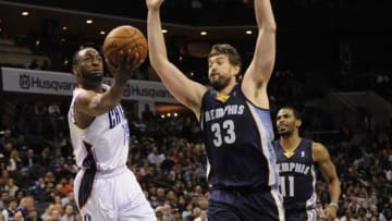 Feb 22, 2014; Charlotte, NC, USA; Charlotte Bobcats guard Kemba Walker (15) moves to the basket for a lay up while defended by Memphis Grizzlies center Marc Gasol (33) during the second half of the game at Time Warner Cable Arena. Bobcats win 92-89. Mandatory Credit: Sam Sharpe-USA TODAY Sports