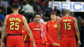 Nov 24, 2015; Atlanta, GA, USA; Atlanta Hawks guard Jeff Teague (0, center) greets guard Thabo Sefolosha (25) and center Al Horford (15) during a timeout in the fourth quarter of their game against the Boston Celtics at Philips Arena. The Hawks won 121-97. Mandatory Credit: Jason Getz-USA TODAY Sports