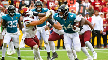 Sep 11, 2022; Landover, Maryland, USA; Jacksonville Jaguars linebacker Travon Walker (44) runs after an interception as Washington Commanders tight end John Bates (87) defends during the second half at FedExField. Mandatory Credit: Brad Mills-USA TODAY Sports