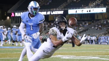 NEW ORLEANS, LA - AUGUST 30: Sage Surratt #14 of the Wake Forest Demon Deacons attempts to catch the ball as Donnie Lewis Jr. #1 of the Tulane Green Wave defends during the second half on August 30, 2018 in New Orleans, Louisiana. (Photo by Jonathan Bachman/Getty Images)