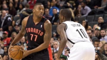 Jan 11, 2014; Toronto, Ontario, CAN; Toronto Raptors shooting guard Julyan Stone (77) battles with Brooklyn Nets point guard Tyshawn Taylor (10) during the 4th quarter in a game at the Air Canada Centre. The Toronto Raptors won 96-80. Mandatory Credit: Nick Turchiaro-USA TODAY Sports