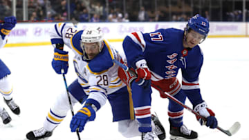 NEW YORK, NEW YORK - NOVEMBER 21: Zemgus Girgensons #28 of the Buffalo Sabres and Kevin Rooney #17 of the New York Rangers fight for the puck after a face off at Madison Square Garden on November 21, 2021 in New York City. (Photo by Elsa/Getty Images)