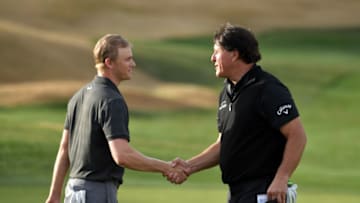 LA QUINTA, CALIFORNIA - JANUARY 20: Adam Long of the United States shakes hands with Phil Mickelson of the United States after winning the final round of the Desert Classic at the Stadium Course on January 20, 2019 in La Quinta, California. (Photo by Donald Miralle/Getty Images)
