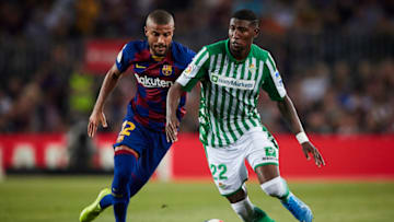 Rafinha of FC Barcelona competes for the ball with Emerson of Real Betis. (Photo by Quality Sport Images/Getty Images)