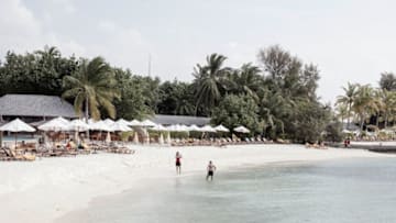 MALE, MALDIVES - FEBRUARY 01: A couple taking photos on the beach in the afternoon during their honeymoon on February 01, 2016 at Centara Ras fushi Resort and Spa, Maldives. China's top diplomats estimates around half a million Chinese tourists this year as the Maldives aim to lure 1.5 million Chinese annually by 2018. The tropical islands remain as one of the most popular holiday destination for Chinese travellers after Thailand's Phuket and South Korea's Jeju island. The number of Chinese tourists continue to climb over the past few years with an increasing number of guest houses popping up on the islands and high end resorts attract holiday seekers with short luxury package deals. (Photo by Giulio Di Sturco/Getty Images)