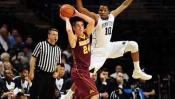 Jan 5, 2016; University Park, PA, USA; Minnesota Golden Gophers forward Joey King (24) passes the ball while being defended by Penn State Nittany Lions forward Brandon Taylor (10) in the first half at Bryce Jordan Center. Mandatory Credit: Evan Habeeb-USA TODAY Sports