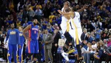 Mar 11, 2015; Oakland, CA, USA; Golden State Warriors forward Draymond Green (23) celebrates with guard Andre Iguodala (9) ahead of Detroit Pistons center Andre Drummond (0) as a timeout is called after Iguodala