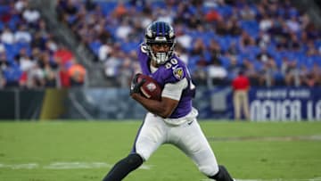 BALTIMORE, MD - AUGUST 11: Isaiah Likely #80 of the Baltimore Ravens carries the ball against the Tennessee Titans during the first half at M&T Bank Stadium on August 11, 2022 in Baltimore, Maryland. (Photo by Scott Taetsch/Getty Images)