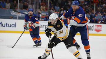 Jun 9, 2021; Uniondale, New York, USA; Boston Bruins left wing Jake DeBrusk (74) plays the puck against New York Islanders right wing Leo Komarov (47) during the third period of game six of the third round of the 2021 Stanley Cup Playoffs at Nassau Veterans Memorial Coliseum. Mandatory Credit: Brad Penner-USA TODAY Sports