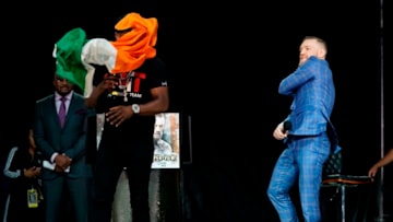 TORONTO, CANADA - JULY 12: (R-L) Conor McGregor throws an Irish flag at Floyd Mayweather Jr. on stage during the Floyd Mayweather Jr. v Conor McGregor World Press Tour event at the Budweiser Stage on July 12, 2017 in Toronto, Ontario, Canada. (Photo by Jeff Bottari/Zuffa LLC/Zuffa LLC via Getty Images)
