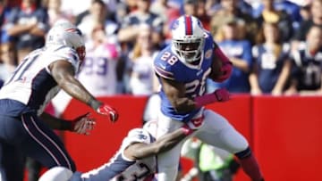 Oct 12, 2014; Orchard Park, NY, USA; Buffalo Bills running back C.J. Spiller (28) is tackled for a loss by New England Patriots cornerback Alfonzo Dennard (37) and outside linebacker Jamie Collins (91) during the first quarter at Ralph Wilson Stadium. Mandatory Credit: Kevin Hoffman-USA TODAY Sports