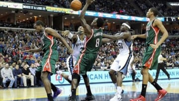 Feb 1, 2014; Memphis, TN, USA; Memphis Grizzlies forward James Johnson (3) is fouled while driving to the basket defended by Milwaukee Bucks forward Khris Middleton (22) and center Larry Sanders (8) as Grizzlies forward Zach Randolph (50) looks on at FedExForum. Memphis defeated Milwaukee 99-90. Mandatory Credit: Nelson Chenault-USA TODAY Sports