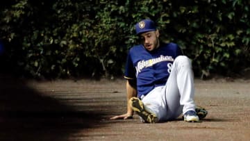 CHICAGO, IL - AUGUST 16: Ryan Braun #8 of the Milwaukee Brewers sits on the ground after suffering an apparent injury after sliding into the wall while chasing a foul ball against the Chicago Cubs during the fourth inning in game two of a double header at Wrigley Field on August 16, 2016 in Chicago, Illinois. (Photo by Jon Durr/Getty Images)