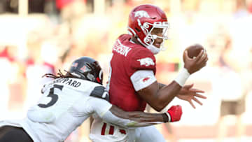 Arkansas Razorbacks quarterback KJ Jefferson avoids Cincinnati Bearcats safety Jaquan Sheppard. USA Today.