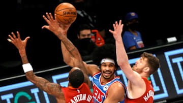 NEW YORK, NEW YORK - JANUARY 12: Jarrett Allen #31 of the Brooklyn Nets passes the ball as Will Barton #5 and Isaiah Hartenstein #25 of the Denver Nuggets defend during the first half at Barclays Center on January 12, 2021 in the Brooklyn borough of New York City. NOTE TO USER: User expressly acknowledges and agrees that, by downloading and or using this Photograph, user is consenting to the terms and conditions of the Getty Images License Agreement. (Photo by Sarah Stier/Getty Images)