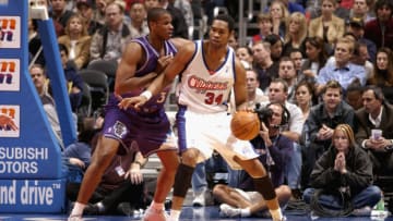 LOS ANGELES - NOVEMBER 26: Michael Olowokandi #34 of the Los Angeles Clippers drives against Jarron Collins #31 of the Utah Jazz during the NBA game at Staples Center on November 26, 2002 in Los Angeles, California. The Jazz won 94-91. NOTE TO USER: User expressly acknowledges and agrees that, by downloading and or using this Photograph, User is consenting to the terms and conditions of the Getty Images License Agreement. Mandatory copyright notice: Copyright 2002 NBAE (Photo by: Andy Hayt/NBAE/Getty Images)