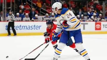 Sep 25, 2022; Washington, District of Columbia, USA; Buffalo Sabres center Dylan Cozens (24) passes teh puck past Washington Capitals center Nic Dowd (26) during the second period at Capital One Arena. Mandatory Credit: Amber Searls-USA TODAY Sports