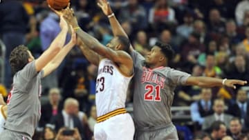 Jan 23, 2016; Cleveland, OH, USA; Cleveland Cavaliers forward LeBron James (23) attempts to shoot the ball between Chicago Bulls center Pau Gasol (16) and guard Jimmy Butler (21) during the third quarter at Quicken Loans Arena. The Bulls won 96-83. Mandatory Credit: Ken Blaze-USA TODAY Sports