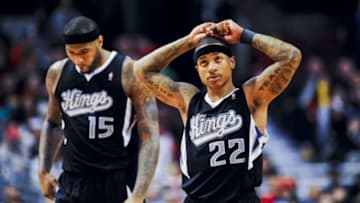 Mar 15, 2014; Chicago, IL, USA; Sacramento Kings center DeMarcus Cousins (15) looks down after he fouled Chicago Bulls forward Mike Dunleavy (not pictured) as Kings guard Isaiah Thomas (22) reacts in the second half of their game against the Bulls at the United Center. The Bulls won 94-87. Mandatory Credit: Matt Marton-USA TODAY Sports