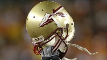 Florida State players hoist helmets December 3 at the 2005 ACC Football Championship Game in Jacksonville. Florida State upset Virginia Tech to win an invitation to the BCC Orange Bowl game. (Photo by A. Messerschmidt/Getty Images) *** Local Caption ***