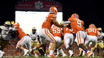 CLEMSON, SOUTH CAROLINA - AUGUST 29: Quarterback Trevor Lawrence #16 hands off the football to running back Travis Etienne #9 of the Clemson Tigers during their football game against the Georgia Tech Yellow Jackets at Memorial Stadium on August 29, 2019 in Clemson, South Carolina. (Photo by Mike Comer/Getty Images)