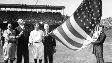 WASHINGTON - APRIL, 1925. On opening day at Griffith Stadium in Washington, D.C. in 1925, the flag raising ceremony involved Yankee manager Joe McCarthy, far right, Washington manager Bucky Harris, third from right, and Senators owner Calvin Griffith, fourth from right. (Photo by Mark Rucker/Transcendental Graphics, Getty Images)