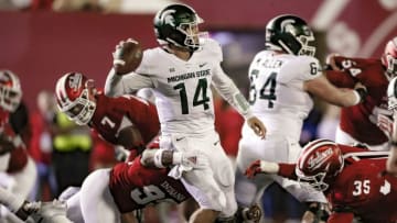 BLOOMINGTON, IN - SEPTEMBER 22: Brian Lewerke #14 of the Michigan State Spartans looks to throw the ball under pressure from Charles Campbell #93 and Nile Sykes #35 of the Indiana Hoosiers at Memorial Stadium on September 22, 2018 in Bloomington, Indiana. (Photo by Michael Hickey/Getty Images)
