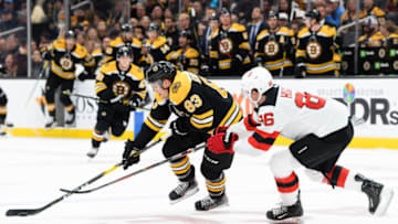 BOSTON, MA - OCTOBER 12: Karson Kuhlman #83 of the Boston Bruins skates past Jack Hughes #86 of the New Jersey Devils in the first period at TD Garden on October 12, 2019 in Boston, Massachusetts. (Photo by Kathryn Riley/Getty Images)