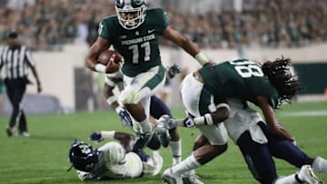 EAST LANSING, MI - AUGUST 31: Connor Heyward #11 of the Michigan State Spartans scores a third quarter touchdown while playing the Utah State Aggies at Spartan Stadium on August 31, 2018 in East Lansing, Michigan. Michigan State won the game 38-31. (Photo by Gregory Shamus/Getty Images)
