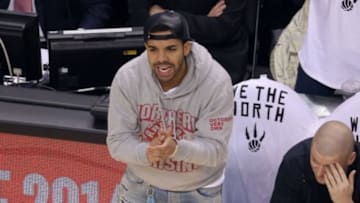 May 4, 2014; Toronto, Ontario, CAN; Musical artist Drake cheers during the game against the Brooklyn Nets in game seven of the first round of the 2014 NBA Playoffs at Air Canada Centre. The Nets beat the Raptors 104-103. Mandatory Credit: Tom Szczerbowski-USA TODAY Sports
