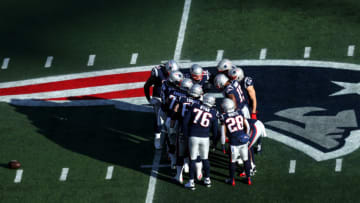 FOXBOROUGH, MASSACHUSETTS - DECEMBER 29: Tom Brady #12 of the New England Patriots huddles with teammates during the game against the Miami Dolphins over the Patriots logo at Gillette Stadium on December 29, 2019 in Foxborough, Massachusetts. (Photo by Maddie Meyer/Getty Images)