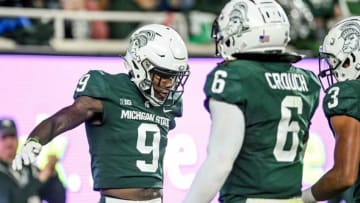 Michigan State's Ronald Williams, left, celebrates with Quavaris Crouch after a stop against Western Kentucky during the first quarter on Saturday, Oct. 2, 2021, at Spartan Stadium in East Lansing.211002 Msu Wku Fb 094a