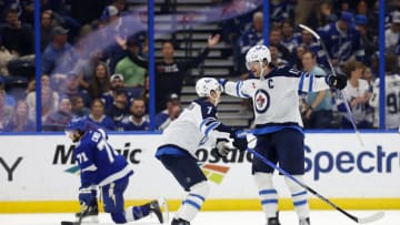 TAMPA, FLORIDA - NOVEMBER 22: Adam Lowry #17 of the Winnipeg Jets celebrates a goal in overtime during a game against the Tampa Bay Lightning at Amalie Arena on November 22, 2023 in Tampa, Florida. (Photo by Mike Ehrmann/Getty Images)