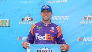 BROOKLYN, MI - AUGUST 10: Denny Hamlin, driver of the #11 FedEx Office Toyota, poses with the pole award after qualifying for the Monster Energy NASCAR Cup Series Consmers Energy 400 at Michigan International Speedway on August 10, 2018 in Brooklyn, Michigan. (Photo by Jerry Markland/Getty Images)