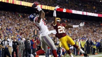 Sep 25, 2014; Landover, MD, USA; New York Giants tight end Larry Donnell (84) catches the ball to score a touchdown as Washington Redskins strong safety Bashaud Breeland (26) defends in the second quarter at FedEx Field. Mandatory Credit: Geoff Burke-USA TODAY Sports