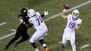 LAS VEGAS, NEVADA - OCTOBER 05: Quarterback Hank Bachmeier #19 of the Boise State Broncos throws a pass as offensive lineman John Ojukwu #70 of the Broncos blocks defensive lineman Nate Neal #91 of the UNLV Rebels during their game at Sam Boyd Stadium on October 5, 2019 in Las Vegas, Nevada. The Broncos defeated the Rebels 38-13. (Photo by Ethan Miller/Getty Images)